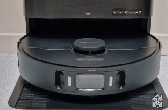 DreameBot X30 Ultra robotic vacuum cleaning in its docking station, showing the AI RGB camera